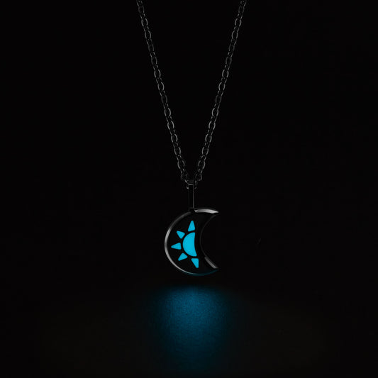 LUNA Necklace with a glowing blue pendant on a black background