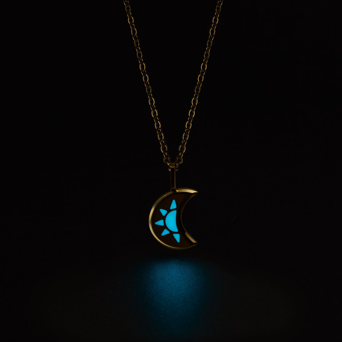 LUNA Necklace with a glowing blue moon and star pendant on a black background