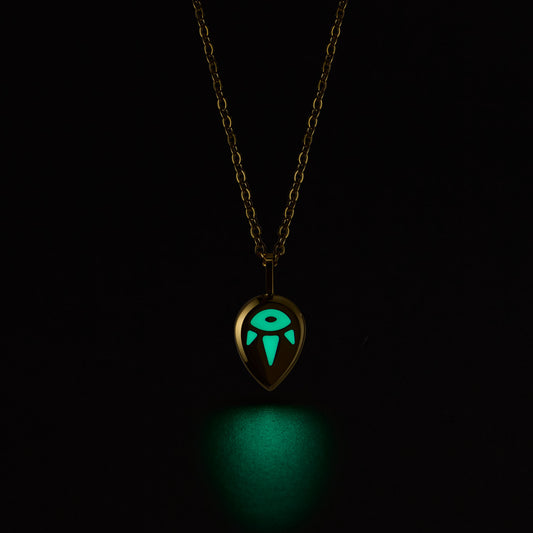 SERENE Necklace with a glowing green pendant on a black background