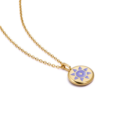 Gold SOLIS necklace with a gold pendant on a purple sun background