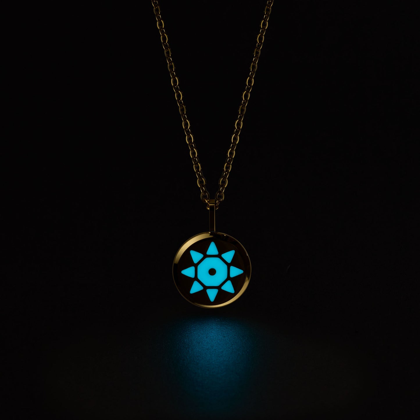 Gold SOLIS necklace with a glowing blue pendant on a black background