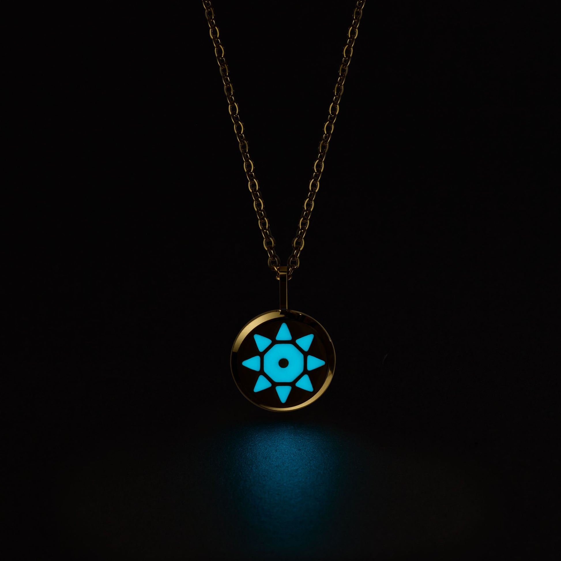 Gold SOLIS necklace with a glowing blue pendant on a black background
