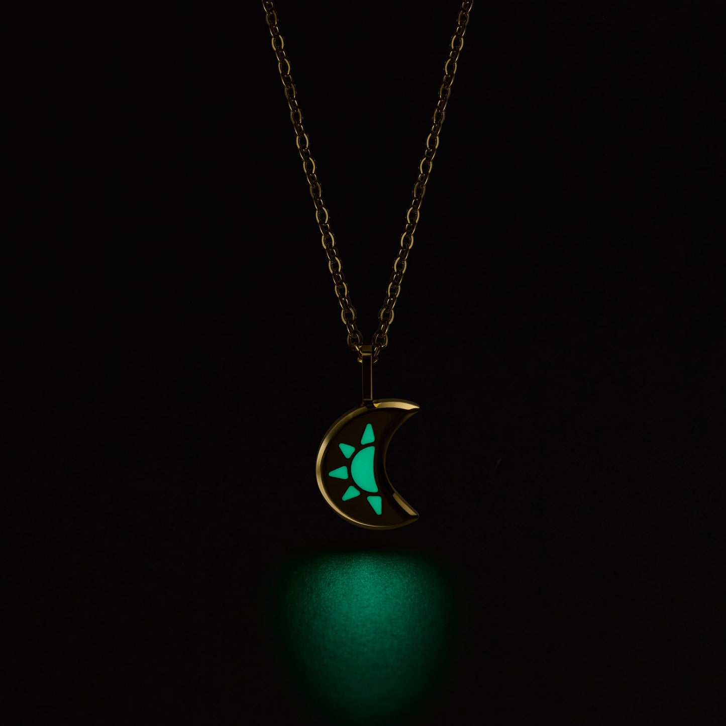 LUNA Necklace with a glowing green moon pendant on a black background