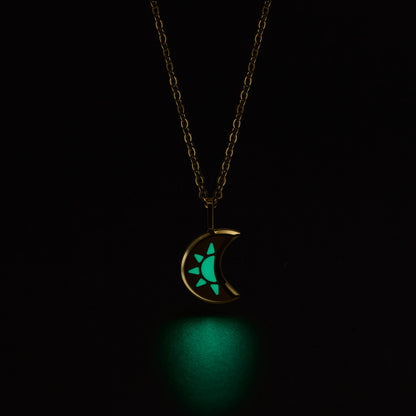 LUNA Necklace with a glowing green moon pendant on a black background