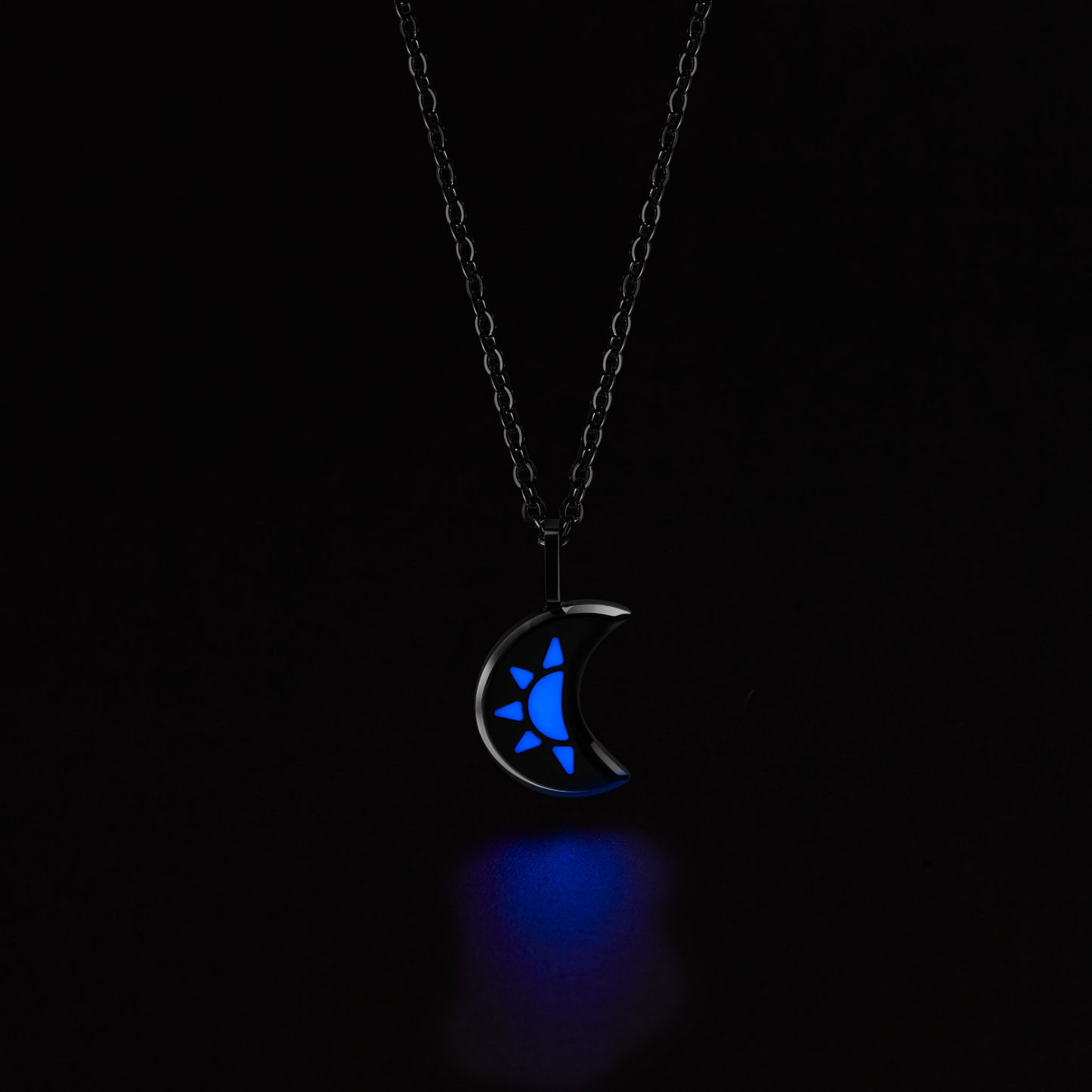 LUNA Necklace with a crescent moon pendant glowing blue in the dark