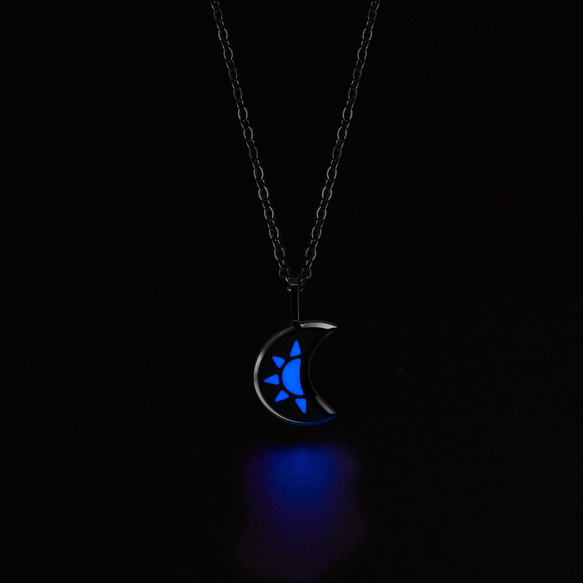 LUNA Necklace with a crescent moon pendant glowing blue in the dark