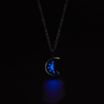 LUNA Necklace with a crescent moon pendant glowing blue in the dark