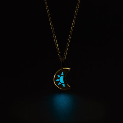 LUNA Necklace with a glowing blue moon and star pendant on a black background
