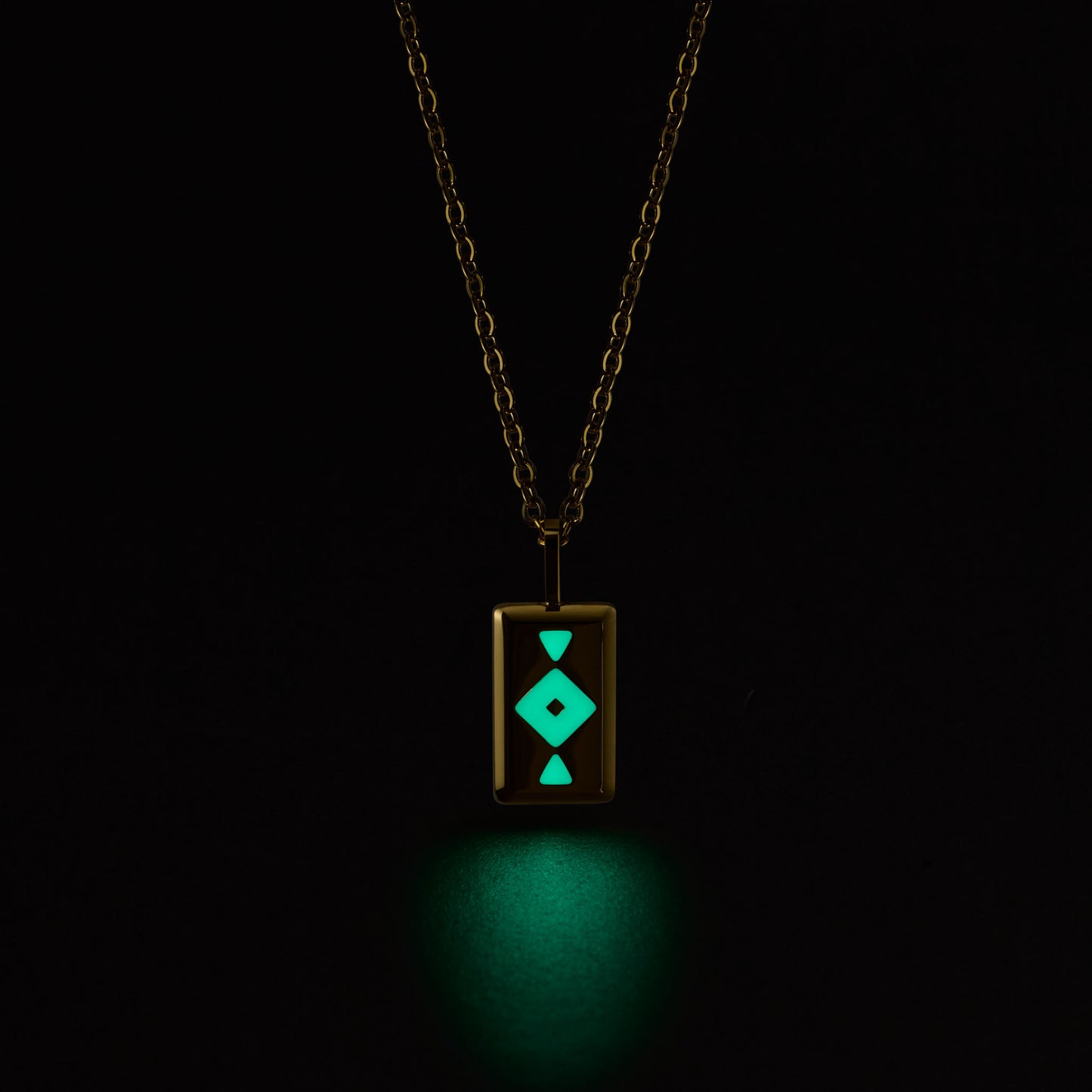 Neon green GAIA pendant on a chain against a black background