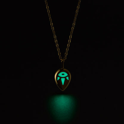 SERENE Necklace with a glowing green pendant on a black background