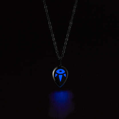 SERENE Necklace with a glowing blue pendant on a black background