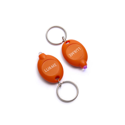 Two orange keychain flashlights with 'LU&ME' branding on a white background